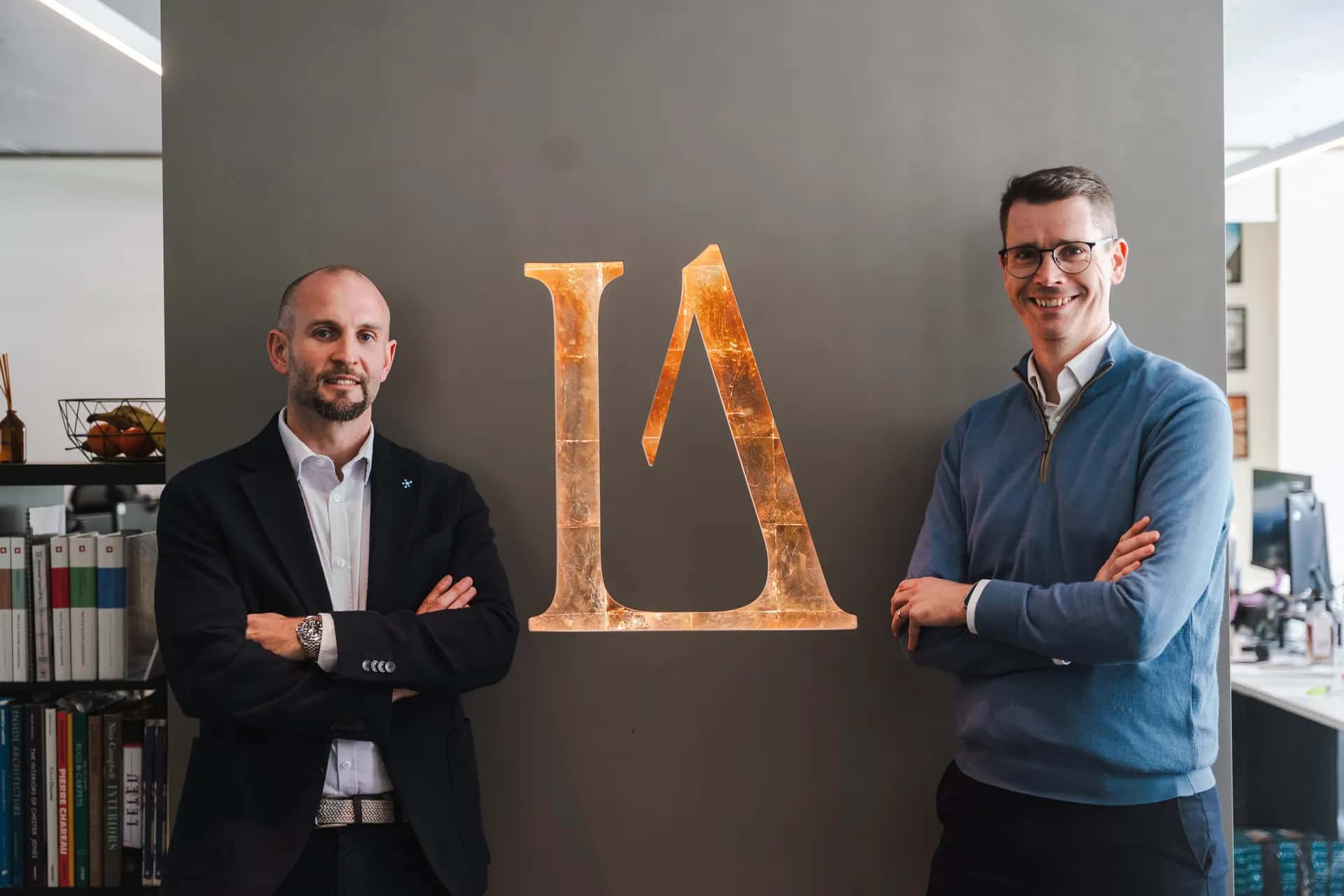Chris and Andrew have their portrait taken standing in front of the LA London sign