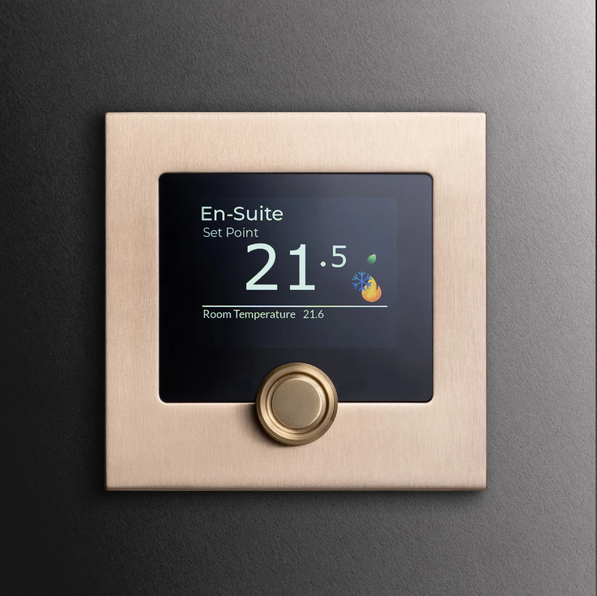 A climate interface in satin brass, dial and display finished to belong in the room, not interrupt it.