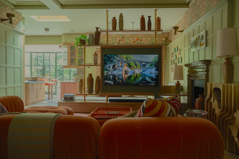 Living room with wall-mounted art-mode TV, soundbar and in-ceiling speakers