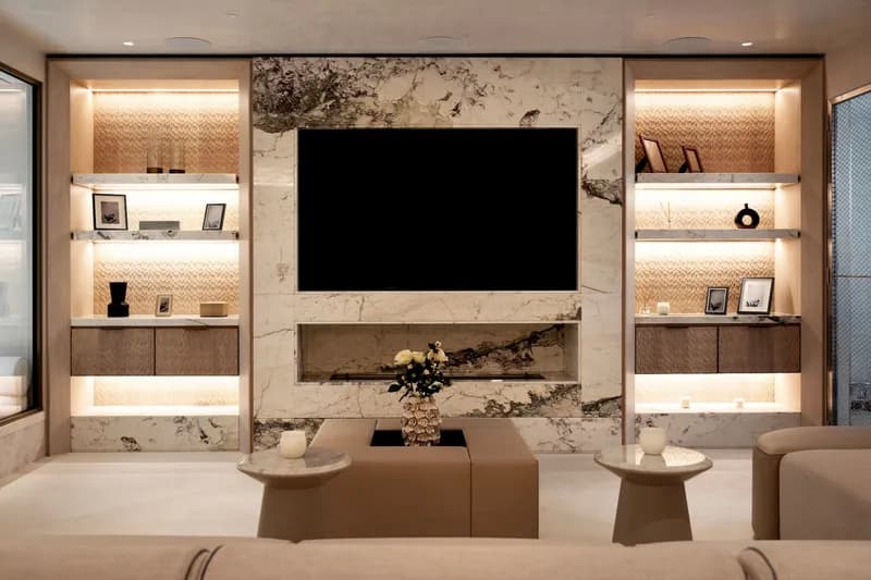 Marble media wall with recessed TV, integrated audio and scene-set lighting in a luxury London residence